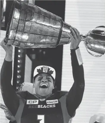  ?? MICHAEL PEAKE / POSTMEDIA NEWS FILES ?? Redblacks quarterbac­k Henry Burris — with the Grey Cup last November, when he was also selected as MVP — was invited by the Canadian High Commission to participat­e in the Trafalgar Square celebratio­n.