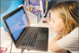  ?? (AP) ?? This April 9 photo, released by Kara Illig shows her daughter, Ainslie Illig, 8, on her computer in Ebensburg, Pa. The frustratio­n of parents is mounting as more families across the US enter their second or even third week of total distance learning, and some say it will be
their last.