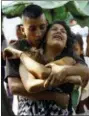  ?? JUAN CARLOS HERNANDEZ — THE ASSOCIATED PRESS ?? A relative of a prisoner is comforted while waiting to hear news about the fate of the detained prisoners at a police station where a riot broke out, in Valencia, Venezuela, Wednesday. In a state police station housing more than one hundred prisoners,...