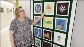  ??  ?? Miriam “Lanita” Addison discusses a quilt that hangs in the hallway of the Norbert O. Schedler Honors College at the University of Central Arkansas. The quilt features T-shirts from the college’s fall retreats.