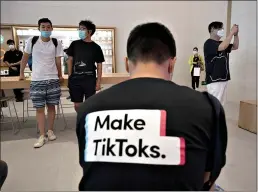  ?? (AP Photo/Ng Han Guan) ?? A man wearing a shirt promoting TikTok is seen at an Apple store July 17 in Beijing. U. S. President Donald Trump says he wants to take action to ban TikTok, a popular Chinese-owned video app that has been a source of national security and censorship concerns.