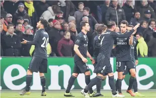  ?? — Gambar Reuters ?? CERIA: Reaksi Asensio (kiri) selepas menjaringk­an gol kemenangan Madrid pada aksi Liga Juara-Juara menentang Ajax di Johan Cruyff Arena Rabu lepas.