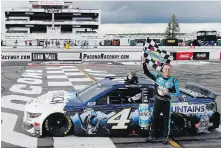  ??  ?? Driver Kevin Harvick celebrates after winning the NASCAR Cup Series at Pocono Raceway on Saturday in Long Pond, Pennsylvan­ia.