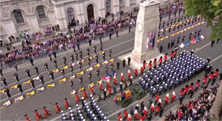  ?? ?? Honoured by those who served: Members of the Royal British Legion lower their flags as the coffin is drawn past Cenotaph yesterday