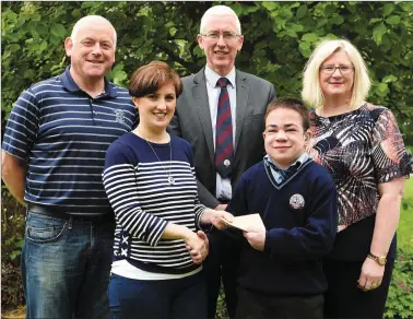  ??  ?? Teacher Annette O’Neill presenting the proceeds of the Genes ‘Jeans’ Day at St Brendan’s College by teachers, students and parents €1085 to Shane and Deirdre McGlynn for Rare Disease with (left) Sean Moynihan SNA and Sean Coffey Principal at St...
