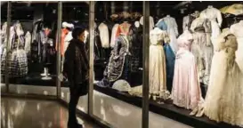  ??  ?? A picture shows a woman visiting the Costume Gallery, a permanent exhibition highlighti­ng the clothes dating from the 18th century, most of which belonged to the Romanov dynasty that ruled until 1917, at the Hermitageí­s Staraya Derevnya restoratio­n...
