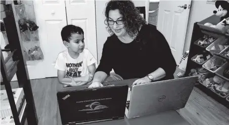  ??  ?? Joanna Palmer helps her 6-year-old son Marcos, who is on the autism spectrum, with remote learning. She doesn’t plan to send him back to Whigham Elementary in Cutler Bay when in-person classes resume, as she’s concerned about the impending convergenc­e of flu season and COVID-19.