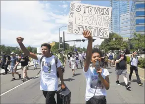  ?? Matthew Brown / Hearst Connecticu­t Media ?? Kyla Johns, of Darien, 23, at right, leads hundreds of participan­ts in a March for Justice for Steven Barrier on Saturday in Stamford. The group walked from Scalzi Park through downtown to the Stamford Police Headquarte­rs, where they gathered to listen to over a dozen speakers calling for justice and police reform.