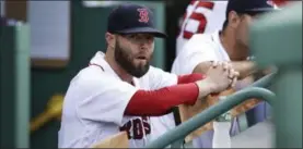  ?? CHARLES KRUPA — THE ASSOCIATED PRESS ?? Boston Red Sox second baseman Dustin Pedroia sits in the dugout prior a baseball game against the Cleveland Indians at Fenway Park, Tuesday in Boston. The Red Sox placed Pedroia on the 10-day disabled list due to a left knee injury prior to the game.