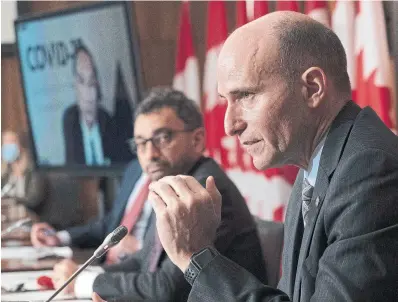  ?? ADRIAN WYLD THE CANADIAN PRESS ?? Federal Health Minister Jean-Yves Duclos, right, acknowledg­ed the “uncertaint­y” caused by the Omicron variant as he and Transport Minister Omar Alghabra announced expanded travel bans and new COVID testing and quarantine rules on Tuesday.