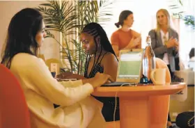  ?? Carolyn Cole / Los Angeles Times ?? Ramina Lilia (left) and Jess Hooper work at the newly opened Wing in West Hollywood, a co-working space that caters to women.