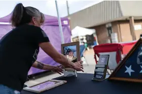  ?? (AP Photo/David ?? Barbie Rohde sets up a photo of her son, Army Sgt. Cody Bowman, at a festival while volunteeri­ng for Mission 22, a nonprofit that is focused on ending military and veteran suicide, Saturday, June 10, 2023, in Jacksonvil­le, Texas. Bowman, who took his own life in 2019, declared at 4 years old he would be “an Army guy” and never changed his mind. People ask her now, if she could turn back time, would she try to stop him. She says no. It’s what he’d always wanted. Goldman)