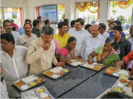  ?? — PTI ?? Andhra Pradesh chief minister N. Chandrabab­u Naidu enjoys lunch during the launch of Phase I of “Anna Canteens”, that serves meals for ` 5 in Vijayawada on Wednesday.