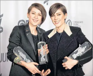  ?? CP PHOTO ?? Tegan and Sara celebrate their three Juno Awards for Pop Album of the Year, Group of the Year and Single of the Year during the Junos in Winnipeg in March 2014.