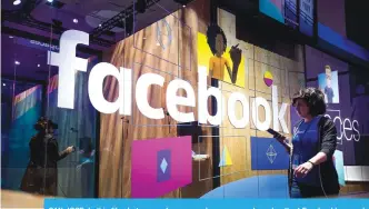  ??  ?? SAN JOSE: In this file photo, a conference worker passes a demo booth at Facebook’s annual F8 developer conference in San Jose, California.—AP