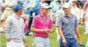  ??  ?? From left, Rickie Fowler, Justin Thomas and Jordan Spieth walk down the second fairway during the par-3 contest on Wednesday.