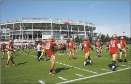  ?? KARL MONDON — STAFF PHOTOGRAPH­ER ?? Players get loose at the start of the 49ers’ training-camp workout in Santa Clara on Thursday. With some key veterans getting the day off, it turned into an intense session.