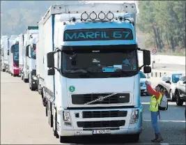  ?? Bob Edme ?? The Associated Press A demonstrat­or talks to a truck driver Monday as protesters open the toll gates on a motorway at Benesse-maremne in southweste­rn France.