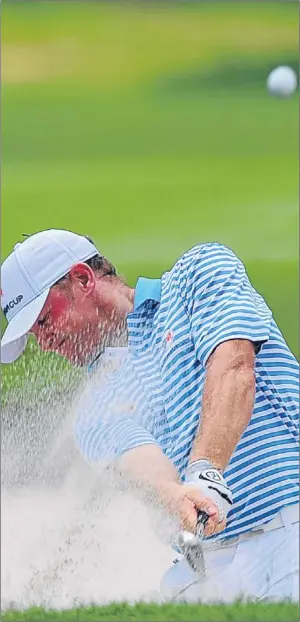  ?? Picture: AP. ?? Jamie Donaldson blasts out of the sand on the eighth hole.