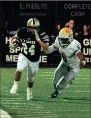  ?? TIM GODBEE / For the Calhoun Times ?? Calhoun’s Zach Fuller (24) runs past Adairsvill­e’s Devon Isaac to gain yardage on a play during the second half.