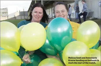  ??  ?? Melissa Snell and Annemarie Greene handing out balloons to mark the start of the match.