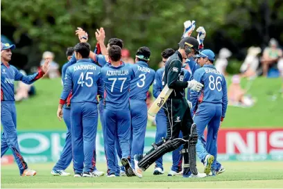  ?? PHOTOSPORT ?? Afghanista­n celebrate the wicket of New Zealand’s Finn Allen at Hagley Oval in Christchur­ch yesterday.