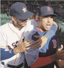  ?? AP PHOTO ?? STAR ATTRACTION: Alex Cora gets a hug from Astros shortstop Carlos Correa last night on his return to Houston, where he served as bench coach last season.