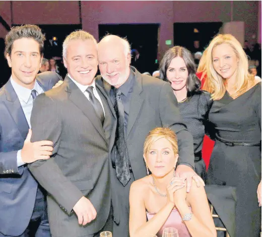  ?? AP ?? James Burrows (standing centre) poses with the cast of ‘Friends’, (from left) David Schwimmer, Matt LeBlanc, Jennifer Aniston (seated), Courteney Cox, and Lisa Kudrow.