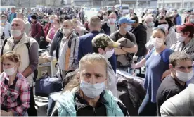  ?? Photograph: Raul Stef/ ?? Romanian seasonal workers waiting to board flights to Germany.