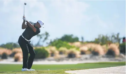  ?? Picture / AP ?? Tiger Woods on the par- 4 fourth hole when he scooped a chip that didn’t reach the green, and then holed an 18- foot par putt.