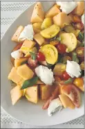  ??  ?? A heartier cantaloupe combinatio­n, this salad brings burrata cheese, tomato slices and olive oil.