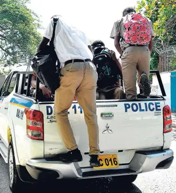  ??  ?? These male students who were seen loitering along North Street, Kingston, last week were ordered into this police vehicle. They were taken to the police station for processing and their parents contacted. As one officer reported, the boys should have been in school at the time they were out on the road.