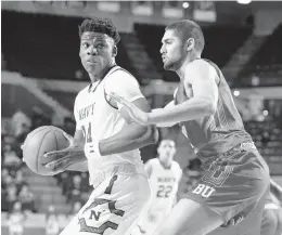  ?? PAUL W. GILLESPIE/CAPITAL GAZETTE ?? Navy's Danny Ogele is guarded by Boston University's Sukhmail Mathon in the first half of Saturday's game at Alumni Hall.