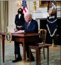  ?? Photo: AFP ?? US President Joe Biden signs an executive order on the economy on Wednesday in the White House.