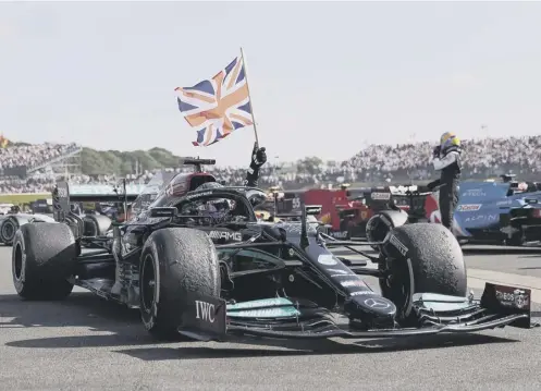  ??  ?? 0 Mercedes’ British driver Lewis Hamilton celebrates after winning the Formula One British Grand Prix motor race at Silverston­e motor racing circuit in Silverston­e