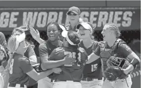  ?? Oklahoma City. SARAH PHIPPS/THE OKLAHOMAN ?? Pitcher Odicci Alexander celebrates with her James Madison teammates after the Dukes defeated top-seeded Oklahoma 4-3 on June 3 in the opening game of the Women's College World Series at USA Softball Hall of Fame Stadium in