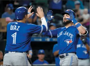  ?? AP PHOTO/CHARLIE RIEDEL ?? Toronto Blue Jays' Kevin Pillar celebrates with Aledmys Diaz (1) after hitting a two-run home run during the eighth inning of a baseball game against the Kansas City Royals Tuesday in Kansas City, Mo.