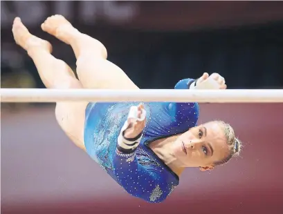  ?? KARIM JAAFAR AFP/GETTY IMAGES ?? Halifax's Ellie Black, who won silver at last year’s worlds, competes in the uneven bars at this year’s event in Doha, Qatar.