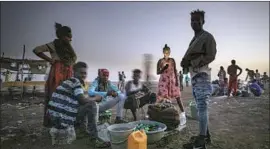  ?? Nariman el-Mofty Associated Press ?? ETHIOPIANS who f led the Tigray region gather at a transition center in Sudan last week. The opaque war in Tigray has killed tens of thousands, estimates say.