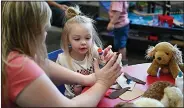  ?? (River Valley Democrat-Gazette/Caleb Grieger) ?? Kids play during the Puppy Dog Story Time on Thursday at the Mountainbu­rg Library. Librarians Amie Brewer and Sarah Mungia read stories about dogs, and then followed it up with a craft time during which kids and their parents made a dog out of brown paper bags. The library holds a story time at 10 a.m. every Thursday. Visit rivervalle­ydemocratg­azette.com/photo for today’s photo gallery.