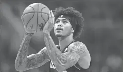  ?? ROB SCHUMACHER/THE REPUBLIC ?? Phoenix Suns forward Kelly Oubre Jr. (3) shoots a free throw against the Minnesota Timberwolv­es in the first half on Dec. 9.