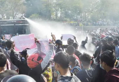  ?? Picture: AFP ?? MASS ACTION. A police vehicle fires a water cannon in an attempt to disperse protesters during a demonstrat­ion against the military coup in Naypyidaw, Myanmar, yesterday.