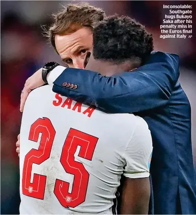  ?? AP ?? Inconsolab­le: Southgate hugs Bukayo Saka after his penalty miss in the Euros final against Italy