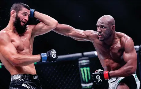  ?? AFP ?? Russia’s Khamzat Chimaev, black, and Nigeria’s Kamaru Usman, white, compete in their middleweig­ht bout during the Ultimate Fighting Championsh­ip 294 event at the Etihad Arena in Abu Dhabi on Oct. 21, 2023.