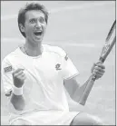  ??  ?? Sergiy Stakhovsky of Ukraine exults after upsetting Roger Federer in the second round of Wimbledon on Wednesday.