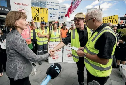  ?? PHOTO: GEORGE HEARD/STUFF ?? Christchur­ch City Council chief executive Dr Karleen Edwards accepts a letter from Rail and Maritime Transport Union members.