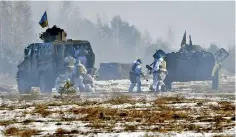  ?? (Photo by Sergei SUPINSKY / AFP) ?? Ukrainian servicemen take part in military exercises by assault units in Zhytomyr region on January 30 amid Russian invasion in Ukraine.