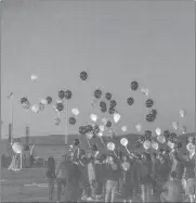  ?? Cory Rubin/The Signal ?? (Above) Peers of Maya Evans release dozens of balloons in her honor at the field at West Ranch High School. (Below) A poster of Evans hangs at the West Ranch lacrosse field. Evans died of leukemia in May.