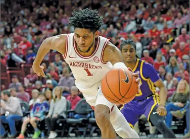  ?? Associated Press ?? Driving: Arkansas guard Isaiah Joe (1) drives against LSU during their SEC clash earlier this month in Fayettevil­le. Joe along with Mason Jones are weighing their options to either enter the NBA Draft or return to Arkansas.