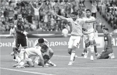  ?? Associated Press ?? Mexico's Hector Moreno, center, celebrates after scoring his side's second goal during the Confederat­ions Cup Group A soccer match between Portugal and Mexico on Sunday at the Kazan Arena, Russia.